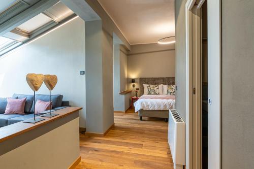 a bedroom with a blue couch and a bed at Cascina Bo in Canelli