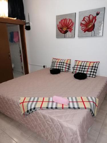 a bedroom with a bed with two pillows on it at HAMBOULA in Polis Chrysochous