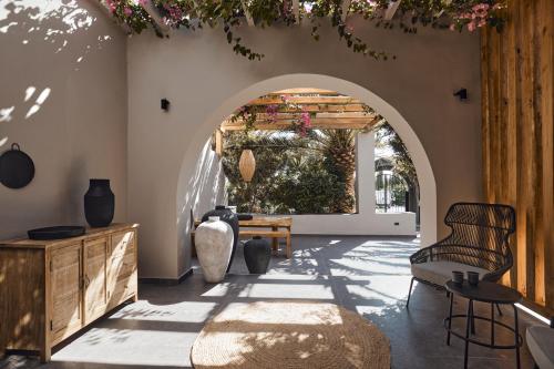 a room with an archway with a table and chairs at Marillia Village in Perivolos