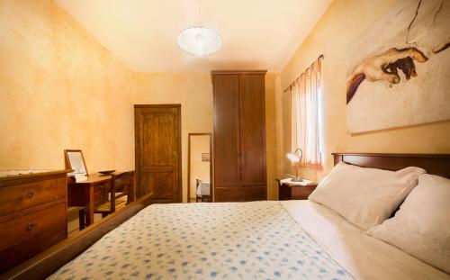a bedroom with a bed and a dresser and a desk at Apartmani Hrelja in Labinci