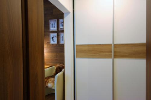 a sliding glass door with a chair in a room at 4Roses Apartments in Smokovce