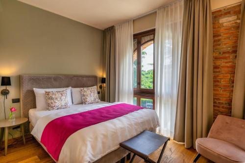 a bedroom with a large bed and a window at Cascina Bo in Canelli