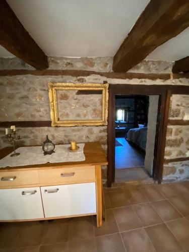 a kitchen with a table and a mirror on the wall at Cottage Modrich in Struga