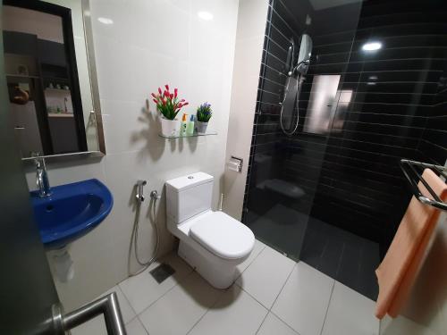a bathroom with a toilet and a shower and a sink at MyCozySOHO with Excellent Swimming Pool View in Cyberjaya