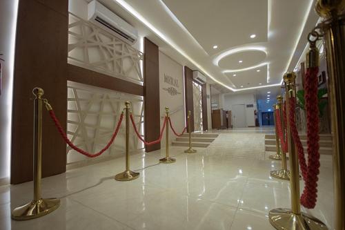a hallway with red rope barriers in a building at منزال الحزم للشقق المخدومة in Ar Rass
