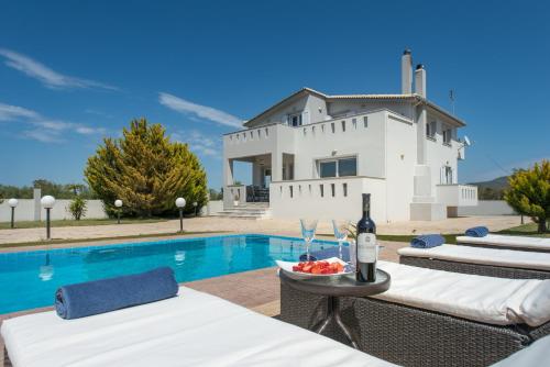 a villa with a swimming pool and a house at Muthee Luxurious Private Villa in Laganas