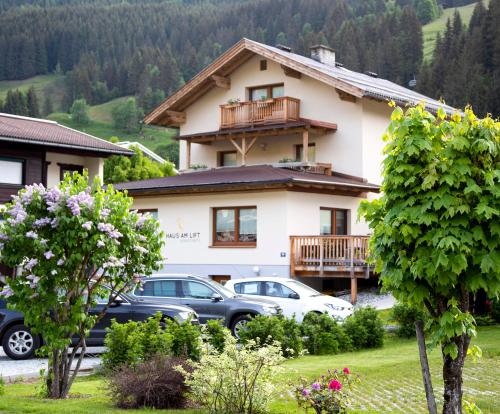 a house with cars parked in front of it at Haus am Lift in Kleinarl