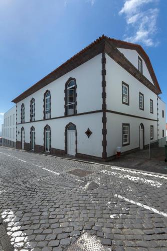 a white building on the side of a street at Azores Youth Hostels - Santa Maria in Vila do Porto