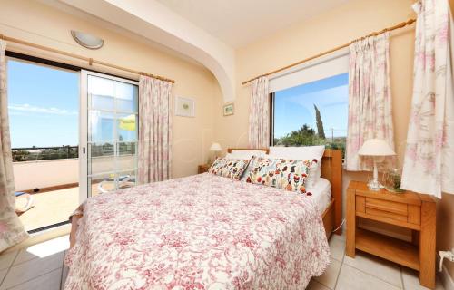 a bedroom with a bed and a large window at CASA BEACHCOMBER Le jardin des Arts in Lagos