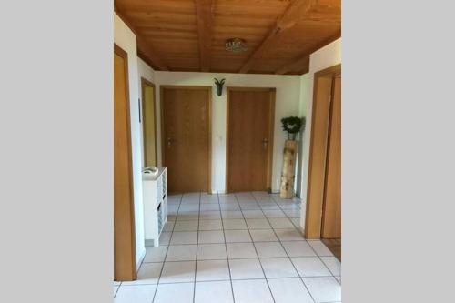 a hallway of a house with a tile floor at Eggelried, wo die Natur zu Hause ist.. in Emmenmatt