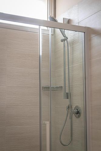 a shower with a glass door in a bathroom at Hotel Astrid in Cervia