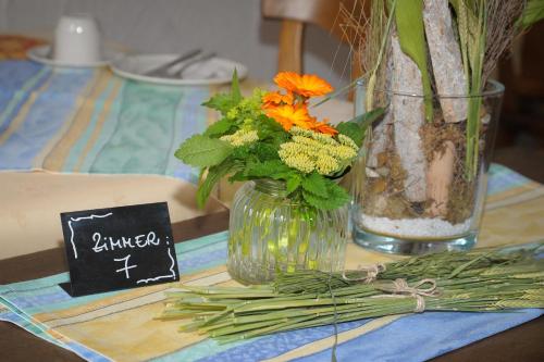 a table with a vase of flowers on a table at Gasthaus Herrig in Meckel