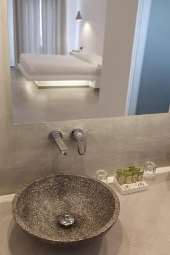 a bathroom with a sink and a mirror at Aeolos Resort in Mýkonos City