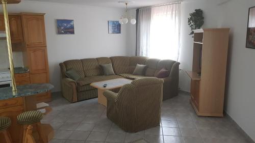a living room with a couch and a table at Royal Apartman in Vonyarcvashegy