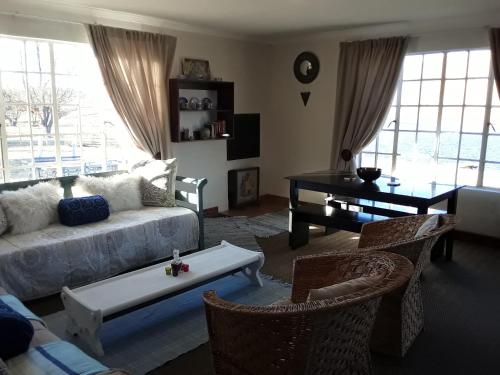 a living room with a couch and a table at Dullstroom on the Dam in Dullstroom