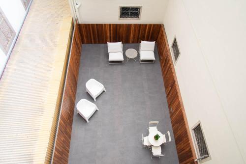an overhead view of a room with chairs and a table at Apartamentos Ferreiros by Heart of Funchal in Funchal