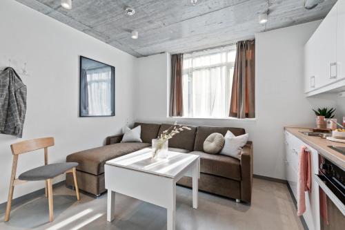 a living room with a couch and a table at Aalesund City Apartment in Ålesund