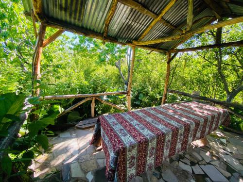 a bed sitting under a roof on a patio at Byurakan Guesthouse & Cottage in Byurakan