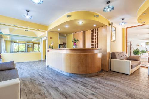 a lobby of a hospital with a counter and chairs at Hotel Bonsai in San Teodoro