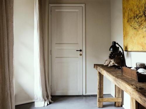 a white door in a room with a wooden table at Palazzo Albricci Peregrini in Como