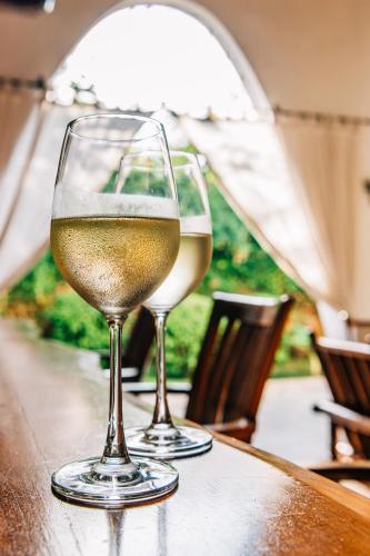 two glasses of white wine sitting on a table at Hotel Villa Malindi in Malindi