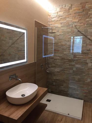 a bathroom with a white sink and a shower at Saint Patrick's INN in Limone Piemonte