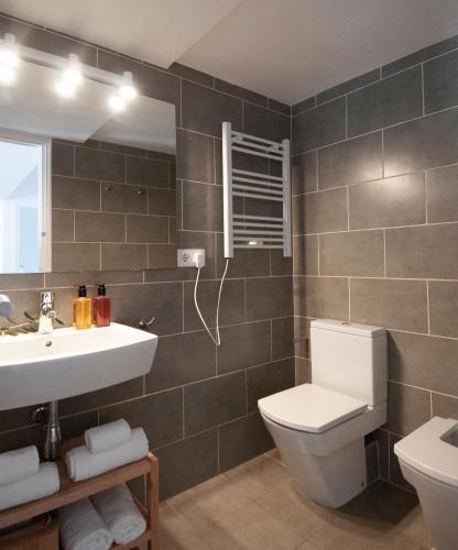 a bathroom with a toilet and a sink at Casa Blanca Beach Apartment in Torredembarra