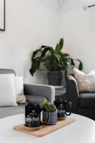 two coffee mugs on a table in a living room at The Film Studio Appartement 5 min to Harry Potter in Leavesden Green