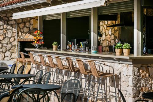 a row of tables and chairs on a patio at Crystal Palace - Luce in Skala Kefalonias