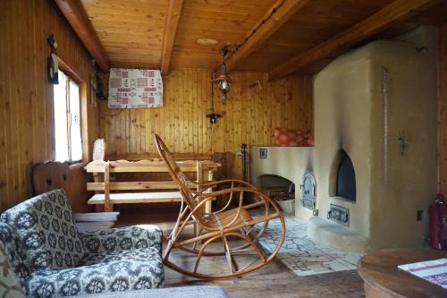 a living room with a chair and a wood stove at Chata Živa pod Babou horou in Oravská Polhora