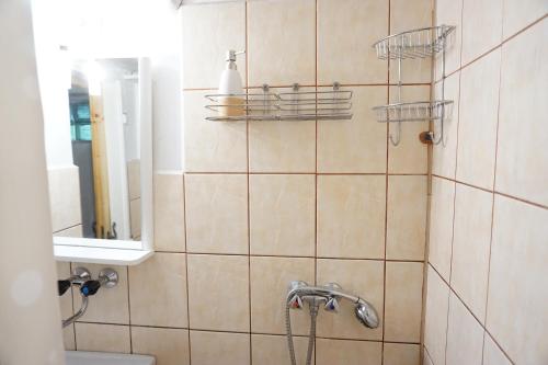 a bathroom with a shower with a sink and a mirror at Chata Živa pod Babou horou in Oravská Polhora