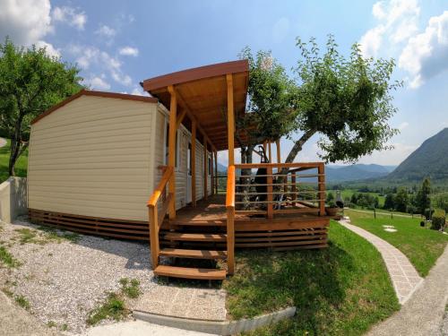 a tiny house with a staircase leading to it at Apartments Denis in Tolmin