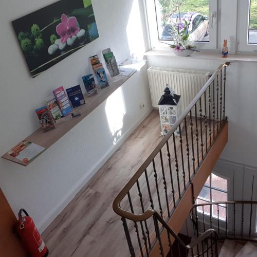 a hallway with a staircase with a wooden floor at Gästehaus Strudthoff in Ganderkesee