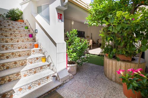 a stairway with potted plants next to a building at V&V Suite & Breakfast in Pompei