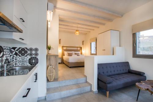 a living room with a couch and a bedroom at CIEL BOUTIQUE VILLAS in Afiartis