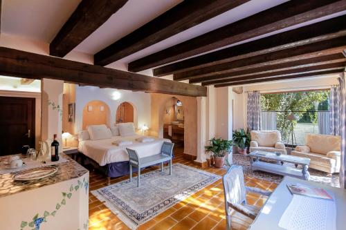 a living room with a bed and a table at Hotel Finca Ca N'ai - Adults Only in Sóller