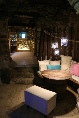 a room with a wooden table and a bench and a table and a stool at Gapphof in Lagundo