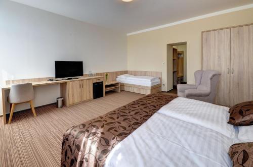 a hotel room with a large bed and a television at Hotel GTC 3* superior in Bílovec