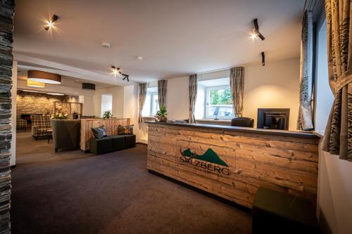 a lobby with a bar and a restaurant at Home-Hotel Salzberg in Berchtesgaden