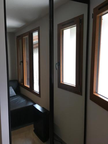 a room with two windows and a bench in it at Mandana in Évian-les-Bains