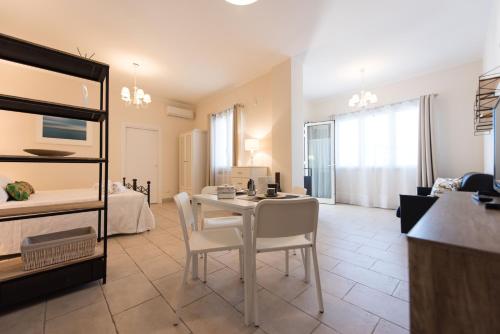 a living room with a table and a bedroom at Residenza Il Sole in Monopoli