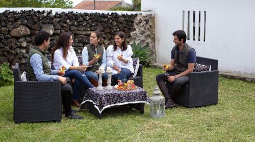 a group of people sitting in chairs around a table at Quinta do Malhinha- Turismo in Angra do Heroísmo