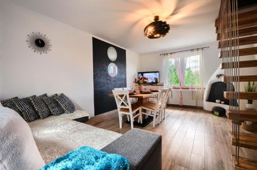 a living room with a couch and a table at Willa Ale Góry Dom na wyłączność , Beskid Żywiecki in Korbielów