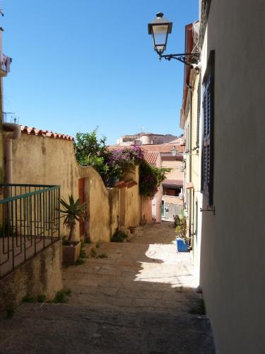 an alley between two buildings with a street light at Clelia's Boutique Rooms & Suites in La Maddalena