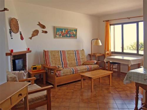 a living room with a couch and a table at Apartamento las camelias 18 in Alaior