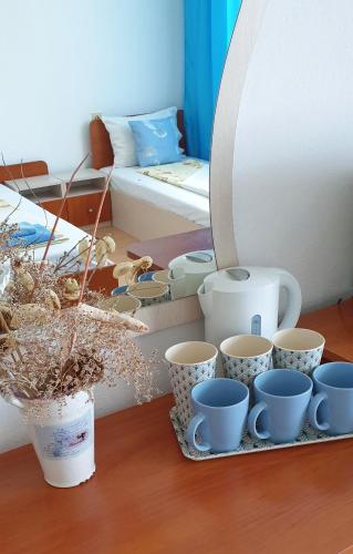 a tray with cups and other items on a table at Майстор Костадин - 1878 in Obzor
