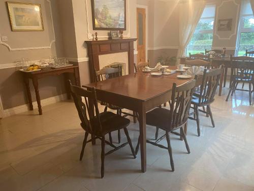 a dining room with a wooden table and chairs at Quignalegan House in Ballina
