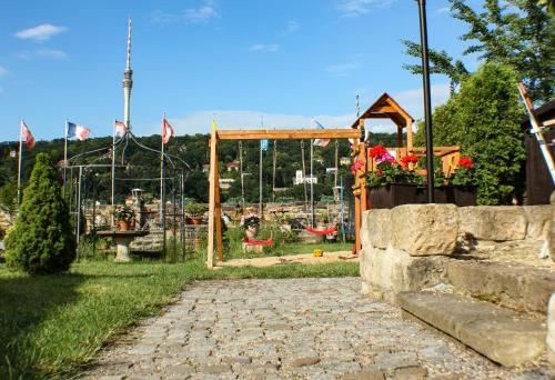 a park with a swing set and a playground at Hotel Alttolkewitzer Hof in Dresden