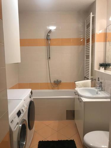a bathroom with a washing machine and a sink at Luna Apartments, apartments with style in Zagreb