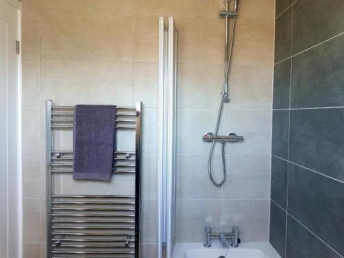 a bathroom with a shower and a tub and a sink at Rayleigh House in Rayleigh